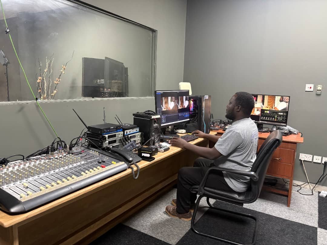 A PCGTV team member operating production equipment in the control room
