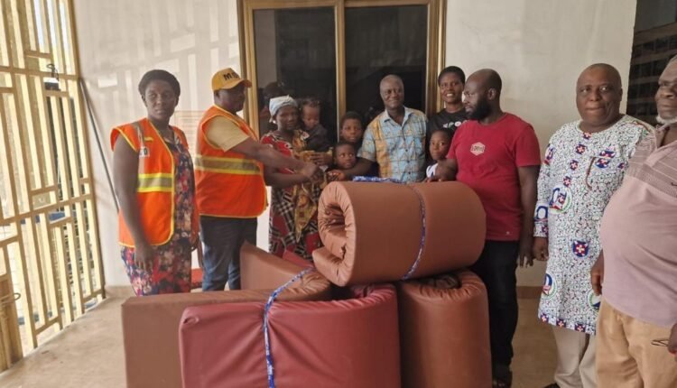 Volunteers and community members gathered around donated household items