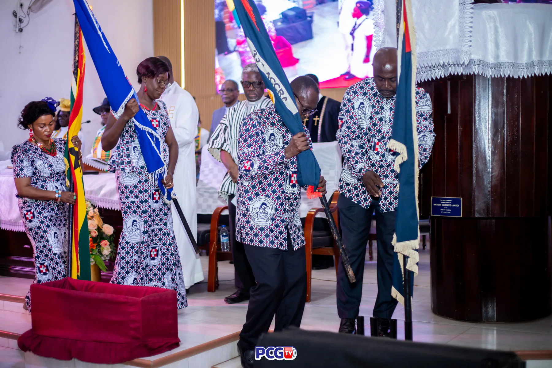 Church members carrying ceremonial flags during a service