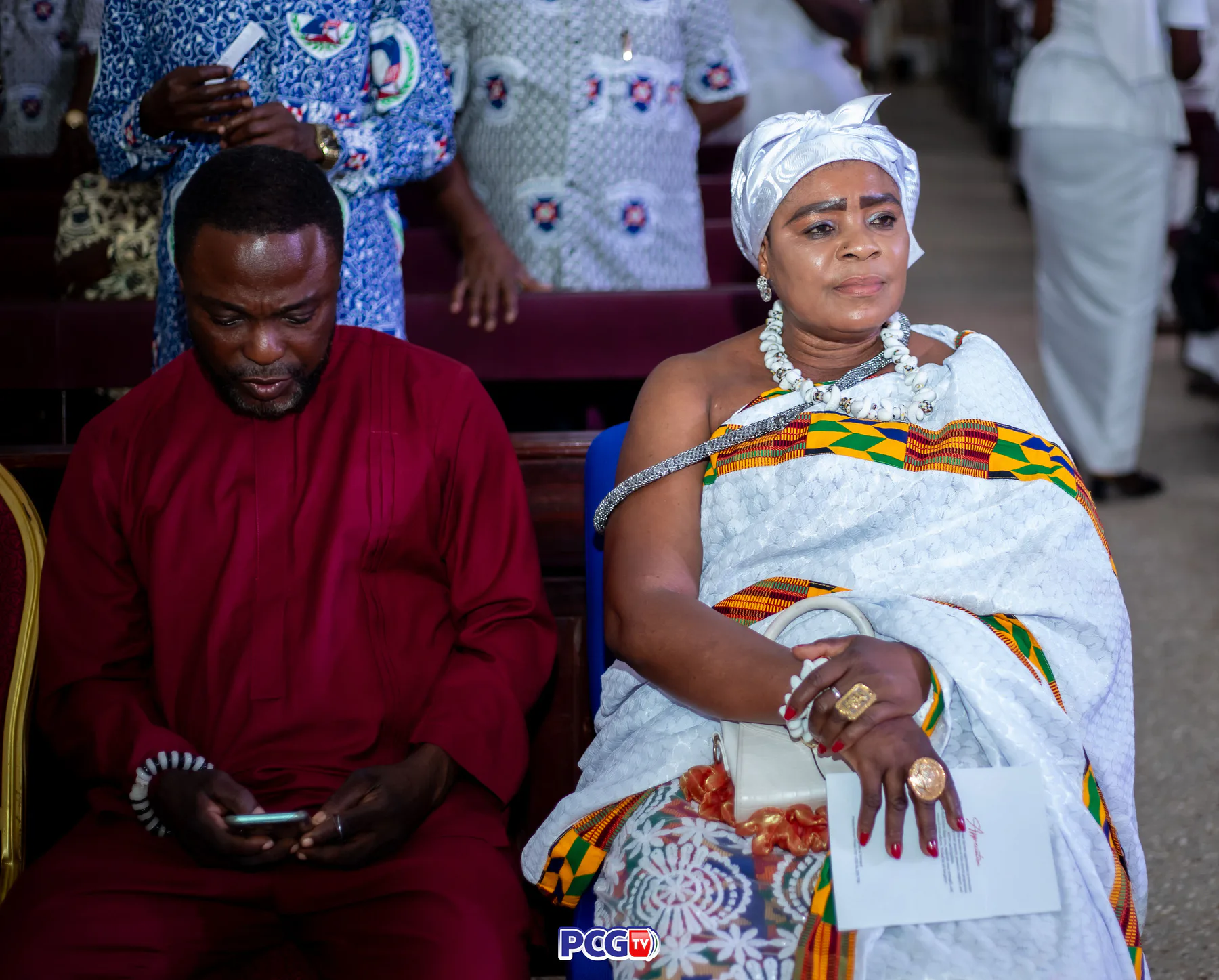 Guests in Ghanaian traditional clothing seated at church