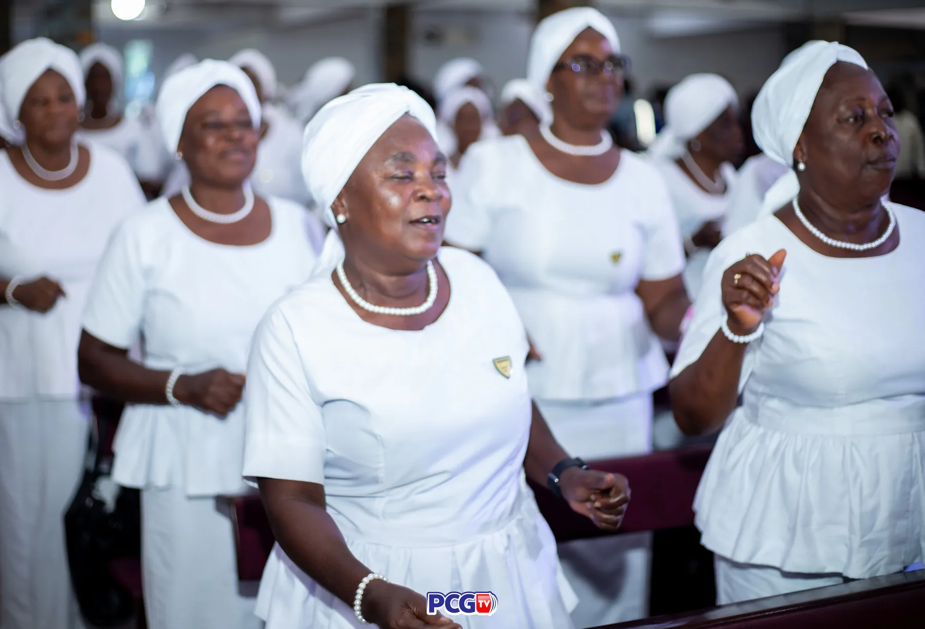 Presbyterian women in white singing together