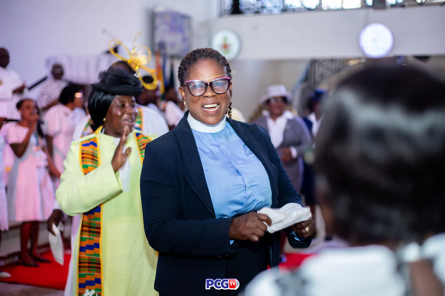 A smiling Presbyterian minister participating in worship