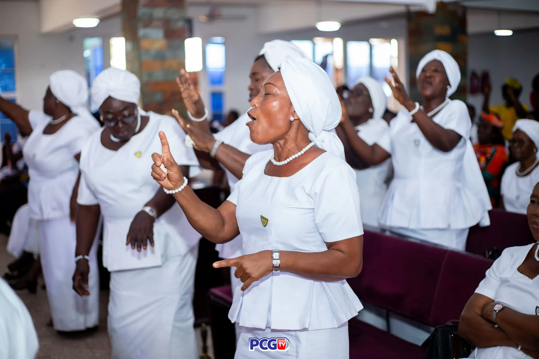 A Presbyterian woman singing with others during worship