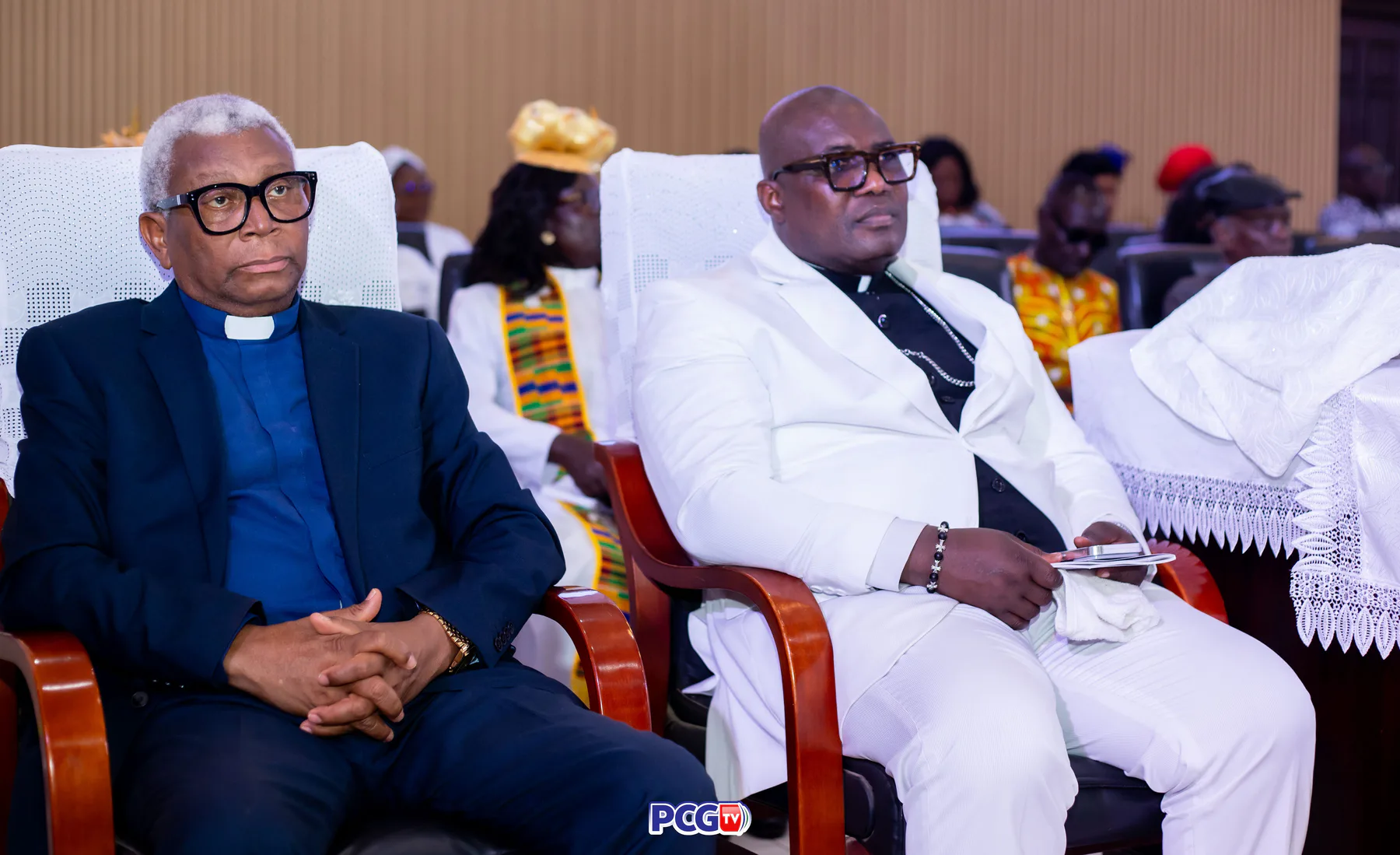 Two male Presbyterian ministers seated during a service