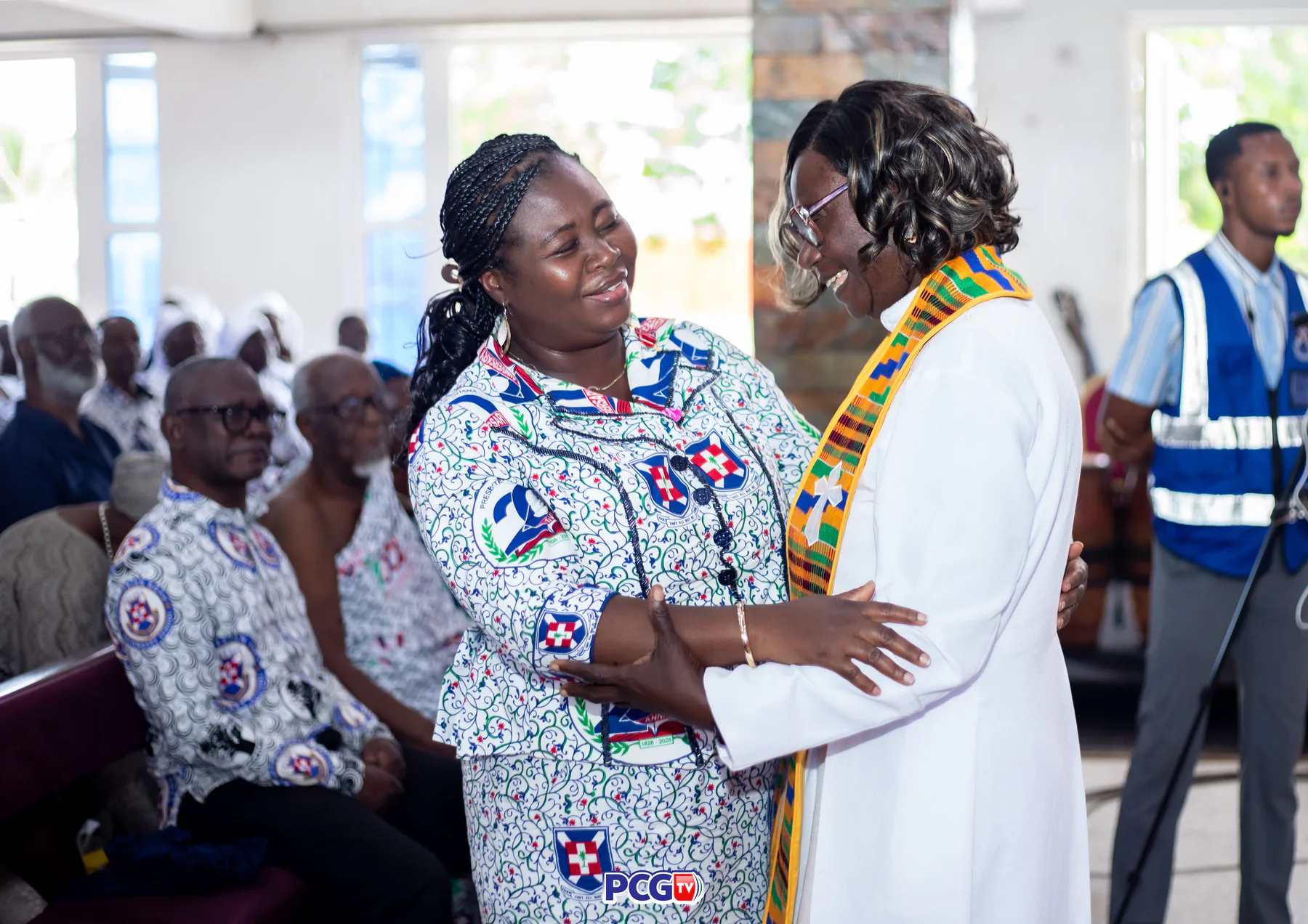 Two Presbyterian women greeting one another during a church service